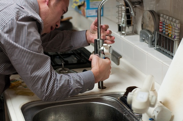 plumber installing faucet